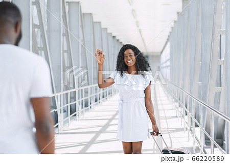 Caring black man meeting his girlfriend at airport Caring black man meeting his girlfriend at airport 66220589