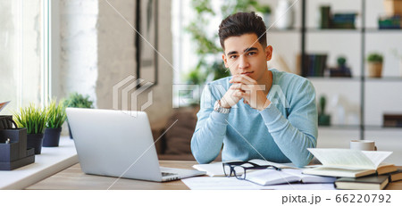 Ethnic freelancer working at home. Ethnic freelancer working at home. 66220792