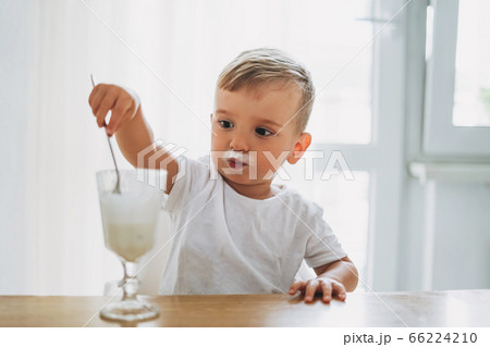 Charming concentrated little baby boy eating Charming concentrated little baby boy eating 66224210
