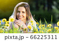 Young beautyful woman lies on the grass and smiling 66225311