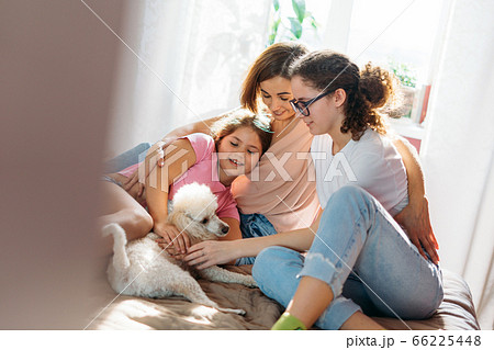 Happy family mother two daughters girls and poodle at home Happy family mother two daughters girls and poodle at home 66225448