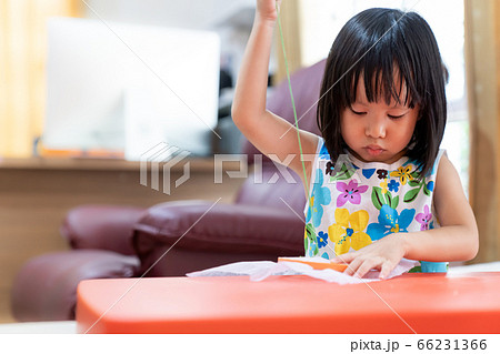 Asian girl home schooling sewing 66231366