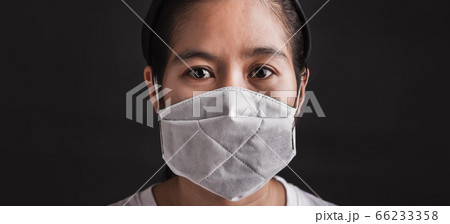 woman wearing protective face mask with fear in woman wearing protective face mask with fear in 66233358