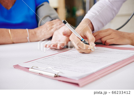General practitioner talking to elderly woman General practitioner talking to elderly woman 66233412