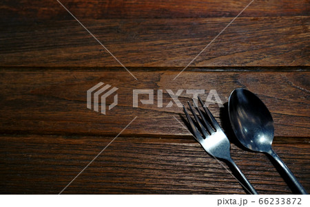 Vintage silverware spoon and fork on rustic wooden Vintage silverware spoon and fork on rustic wooden 66233872