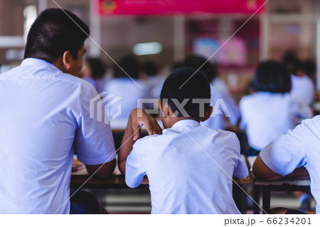 Asian high school students in white uniform are studying in the classroom. Asian high school students in white uniform are studying in the classroom. 66234201
