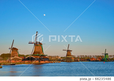 Windmills at Zaanse Schans in Holland in twilight on sunset. Netherlands 66235486