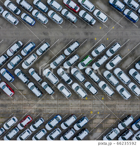 New car lined up aerial view. Port of import and export business logistic to dealership for sale. New car lined up aerial view. Port of import and export business logistic to dealership for sale. 66235592