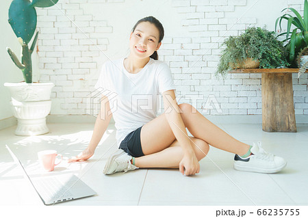 A beautiful woman doing exercise at home A beautiful woman doing exercise at home 66235755