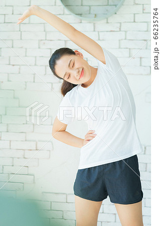 A beautiful woman doing exercise at home 66235764