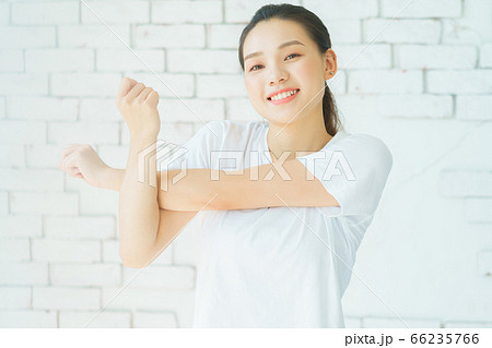 A beautiful woman doing exercise at home A beautiful woman doing exercise at home 66235766