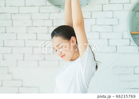 A beautiful woman doing exercise at home 66235769