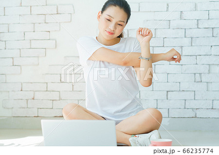 A beautiful woman doing exercise at home 66235774