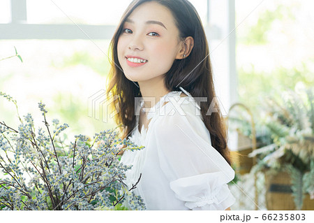 A Beautiful woman in flowers shop 66235803