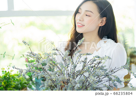 A Beautiful woman in flowers shop 66235804