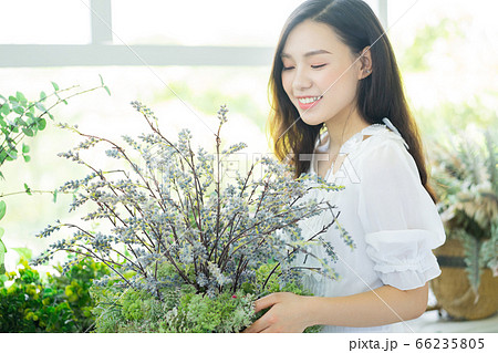 A Beautiful woman in flowers shop A Beautiful woman in flowers shop 66235805