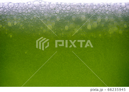 Background of close-up soda bubbles mixed with lemon juice or green juice on white background. Background of close-up soda bubbles mixed with lemon juice or green juice on white background. 66235945