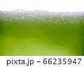 Background of close-up soda bubbles mixed with lemon juice or green juice on white background. 66235947