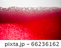 Background of close-up soda bubbles mixed with red fruit juice on white background. 66236162