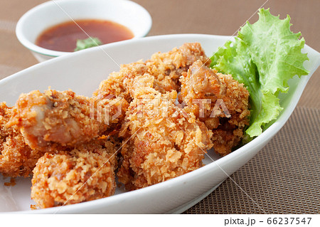 Fried chicken in white bowl served with chili Fried chicken in white bowl served with chili 66237547
