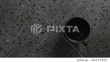 black coffee in black cup on concrete background top view 66237835