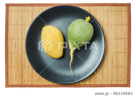 green radish and yellow mango on a gray plate on a 66239084