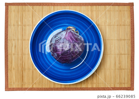 purple head of red cabbage on a blue plate on a purple head of red cabbage on a blue plate on a 66239085