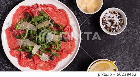 Marbled beef carpaccio with arugula, capers and 66239452