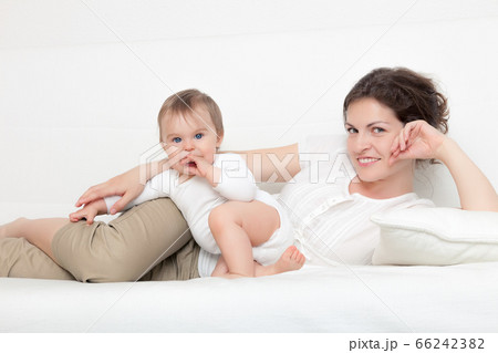 Mother playing with baby Mother playing with baby 66242382