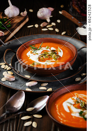 Clay dish with homemade rustic pumpkin soup with 66242528