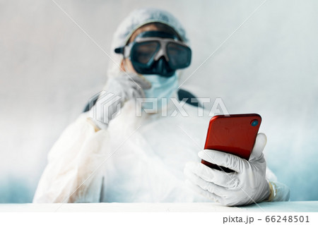 Doctor in the protective suit with smartphone Doctor in the protective suit with smartphone 66248501