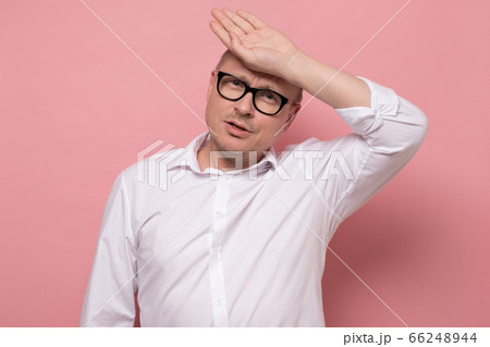 mature man in white shirt is worried and tired during hot summer weather. mature man in white shirt is worried and tired during hot summer weather. 66248944