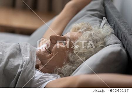 Happy mature woman awaken from good sleep at home 66249117