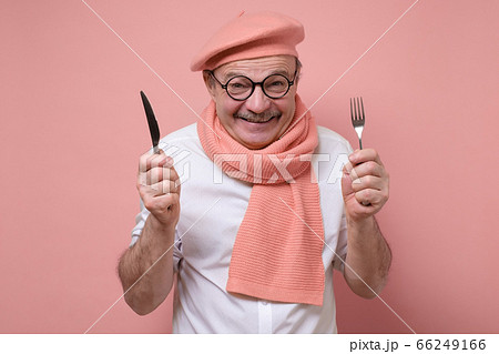 Hungry excited hispanic senior man holding fork and knife on hand ready to eat. Hungry excited hispanic senior man holding fork and knife on hand ready to eat. 66249166