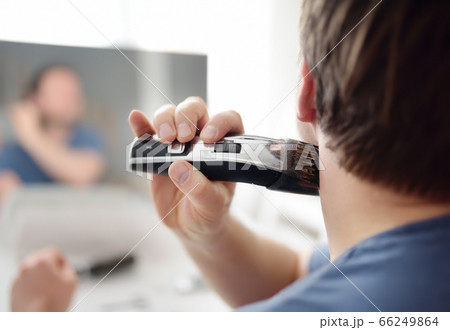 Mature man is shaving off his beard with electric razor Mature man is shaving off his beard with electric razor 66249864