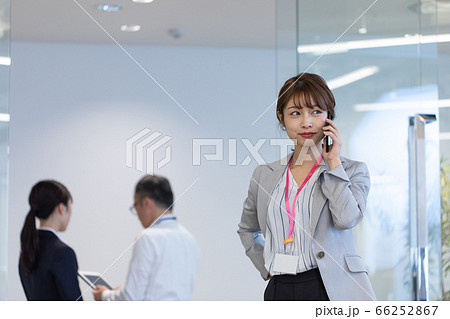 打合せ中にスマホで連絡する女性社員 66252867