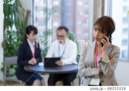 打合せ中にスマホで連絡する女性社員 66253328