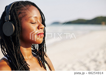 Young woman enjoying relaxing music Young woman enjoying relaxing music 66254914