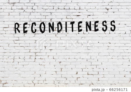 Word reconditeness painted on white brick wall 66256171