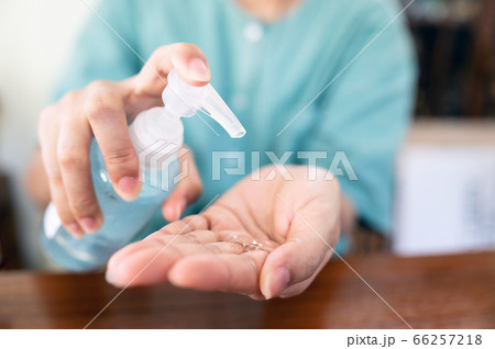 Woman uses a hand washing gel to wash her hands to avoid contamination 66257218