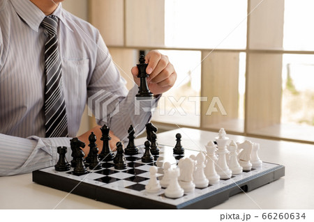 hand of businessman moving chess in competition, shows leadership, followers and business success strategies 66260634