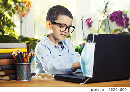 Kid using laptop for his homework,Child doing using laptop searching information on internet 66264809