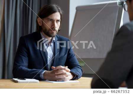 Serious skeptic employer hr manager looks at vacancy candidate applicant 66267352