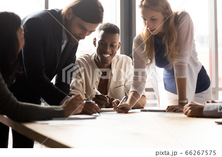 Diverse associates writing project plan and ideas at group meeting 66267575