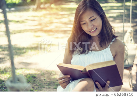 Relax woman holgind bible book read outdoors Relax woman holgind bible book read outdoors 66268310
