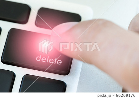 A finger is pushing delete button on keyboard of laptop A finger is pushing delete button on keyboard of laptop 66269176