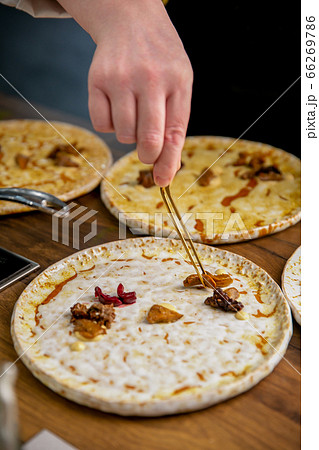 Chef decorates a dish of rabbit tongue and kidneys. Master class in the kitchen. The process of 66269786