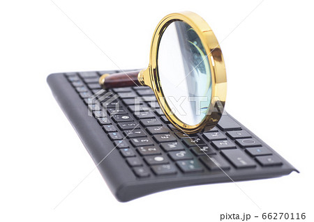 Magnifying Glass on black keyboard Magnifying Glass on black keyboard 66270116