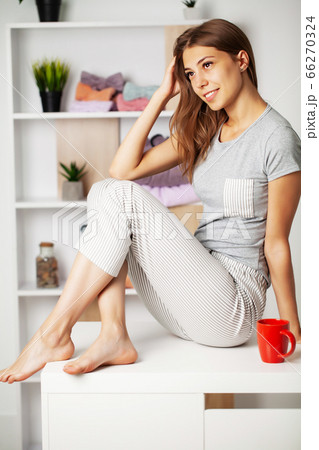 Young woman in pajamas with a beautiful smile in the dressing room Young woman in pajamas with a beautiful smile in the dressing room 66270324