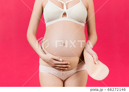 Close up of young pregnant woman in underwear Close up of young pregnant woman in underwear 66272146